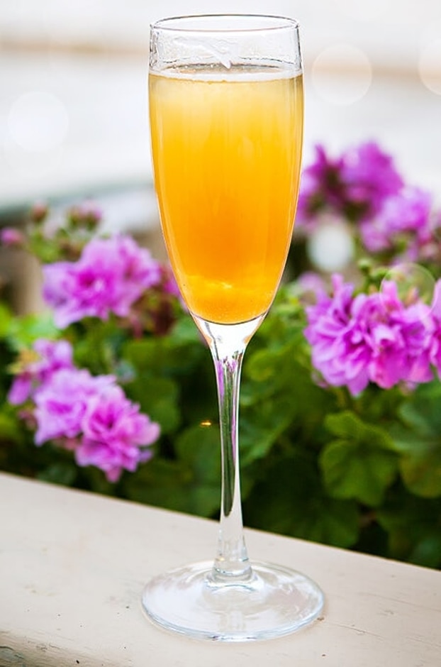 A mimosa made with peach flavored vodka, Prosecco and orange juice.