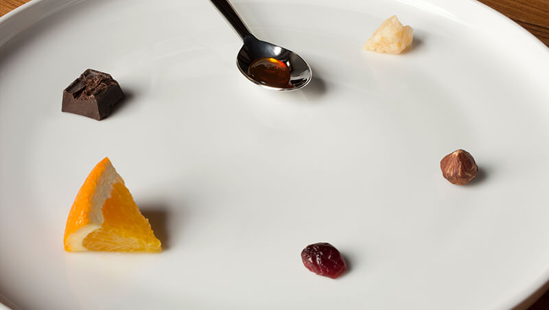 Food samples positioned in a clockwise pattern on a small plate. 