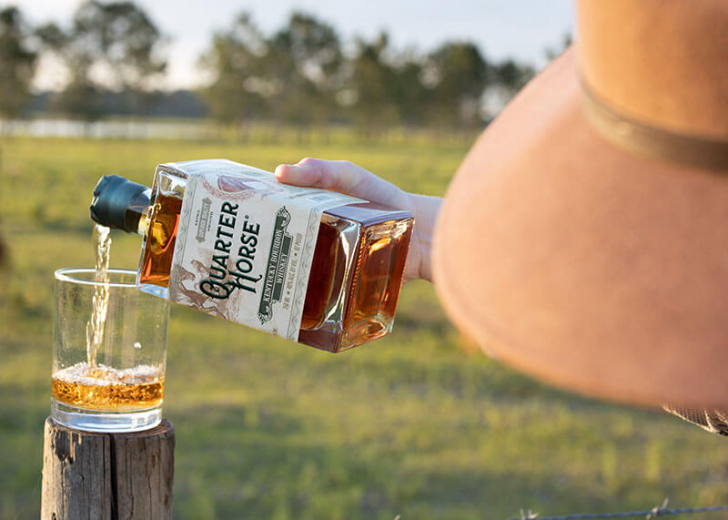 Pouring a glass of Quarter Horse Bourbon.What is the difference between bourbon and whiskey?