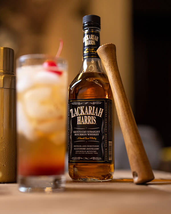 Zackariah Harris Kentucky Straight Bourbon Whiskey in a lifestyle setting with a cocktail