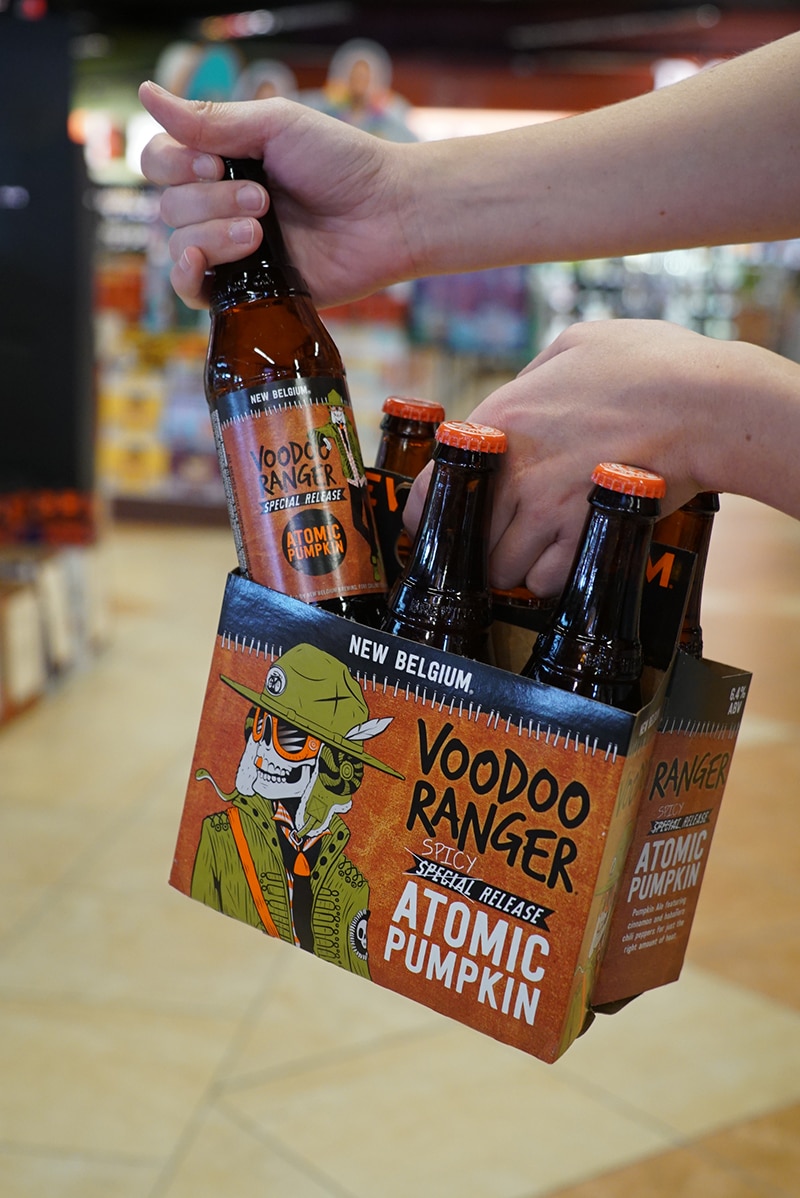 Someone holding a Voodoo Ranger Atomic Pumpkin 6pk bottle.
