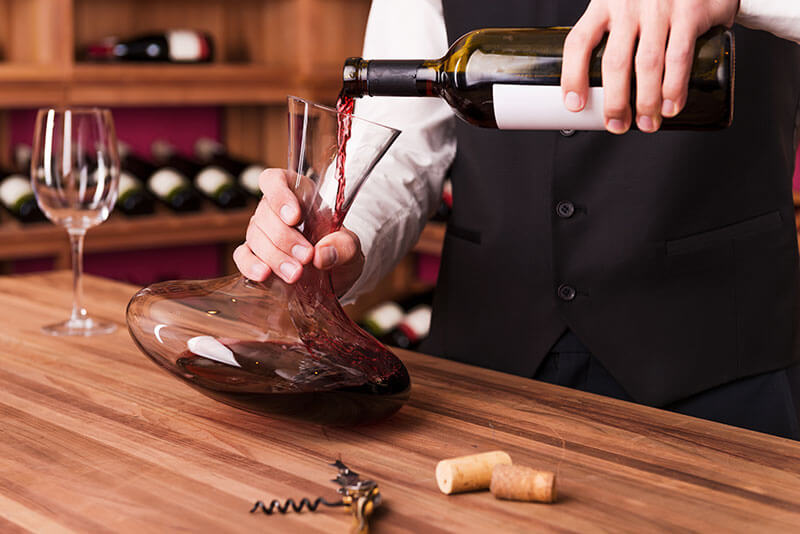 Pouring red wine from ABC Fine Wine & Spirits into a decanter to allow the wine to aerate, opening up flavors and aromas, before serving. Learn why and how to decant your wine with the help of ABC’s wine expert Paul Quaglini.