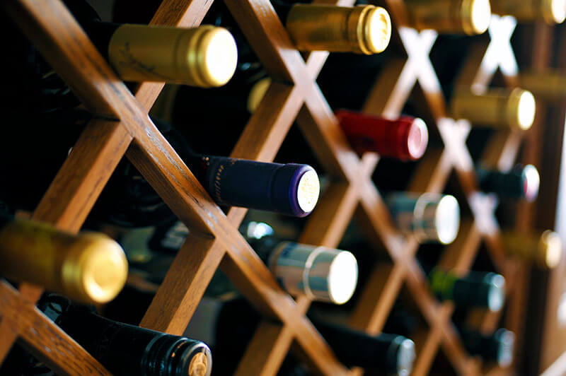 Red and white wines from ABC Fine Wine & Spirits stored in a wine cellar to be open during a dinner party of celebration. Find your favorite wine at your local ABC store and book a free consultation through ABC’s Concierge service for a seamless party planning experience.